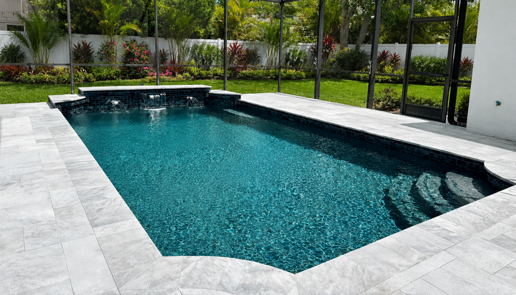 Modern Pool Renovation with Dark Tile & Travertine Deck in Bradenton — Nelson Pool Company
