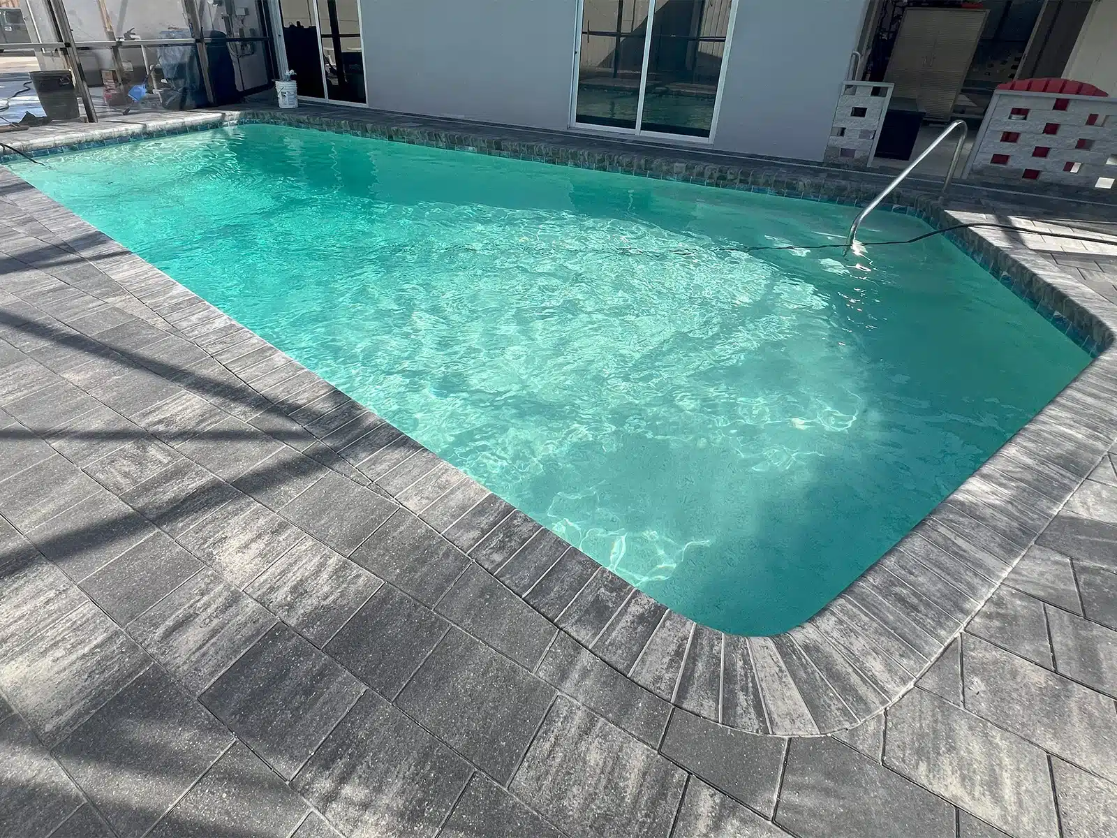 Before and after pool resurfacing and paver deck transformation in Bradenton FL — after
