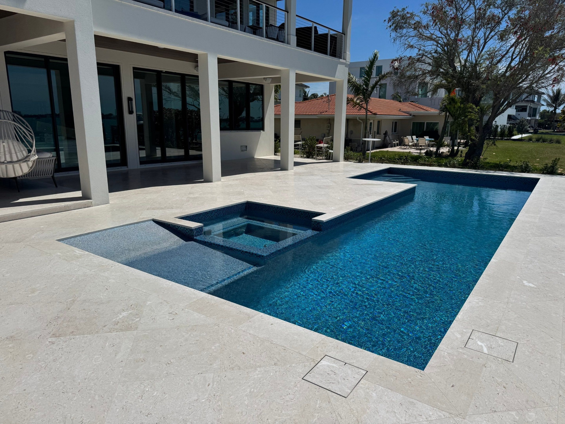 Before and after pool resurfacing in Sarasota FL with Pebble Tec Aqua Essence by Nelson Pool Company — after