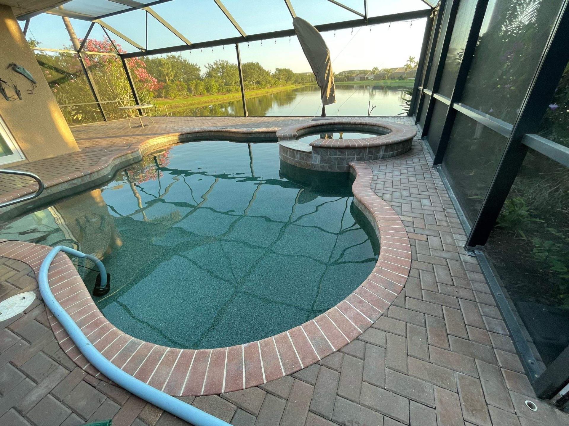 Before and after pool remodel in Anna Maria FL with Alaskan Silver Travertine and Luv Tile by Nelson Pool Company — before
