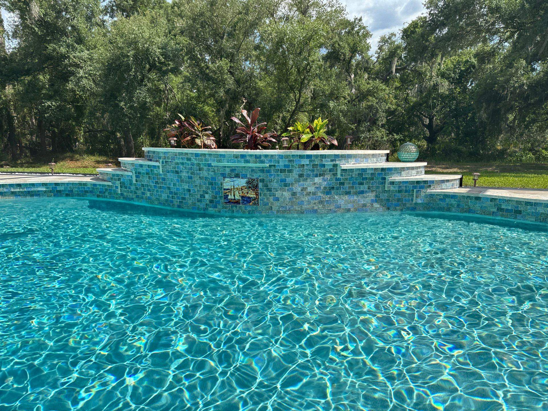 Before and after pool renovation in Lakewood Ranch FL with StoneScapes Aqua Cool and Luv Tile by Nelson Pool Company — after