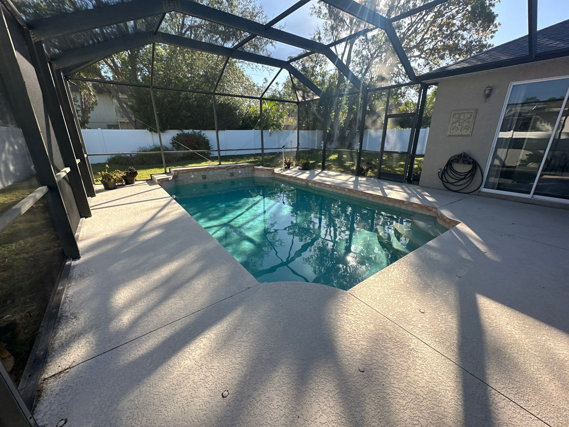 Before and after pool renovation in Bradenton FL with Bianca Rikara Marble, Aquabella Britannia, Luv Tile, and StoneScapes Rubicon Bay by Nelson Pool Company — before