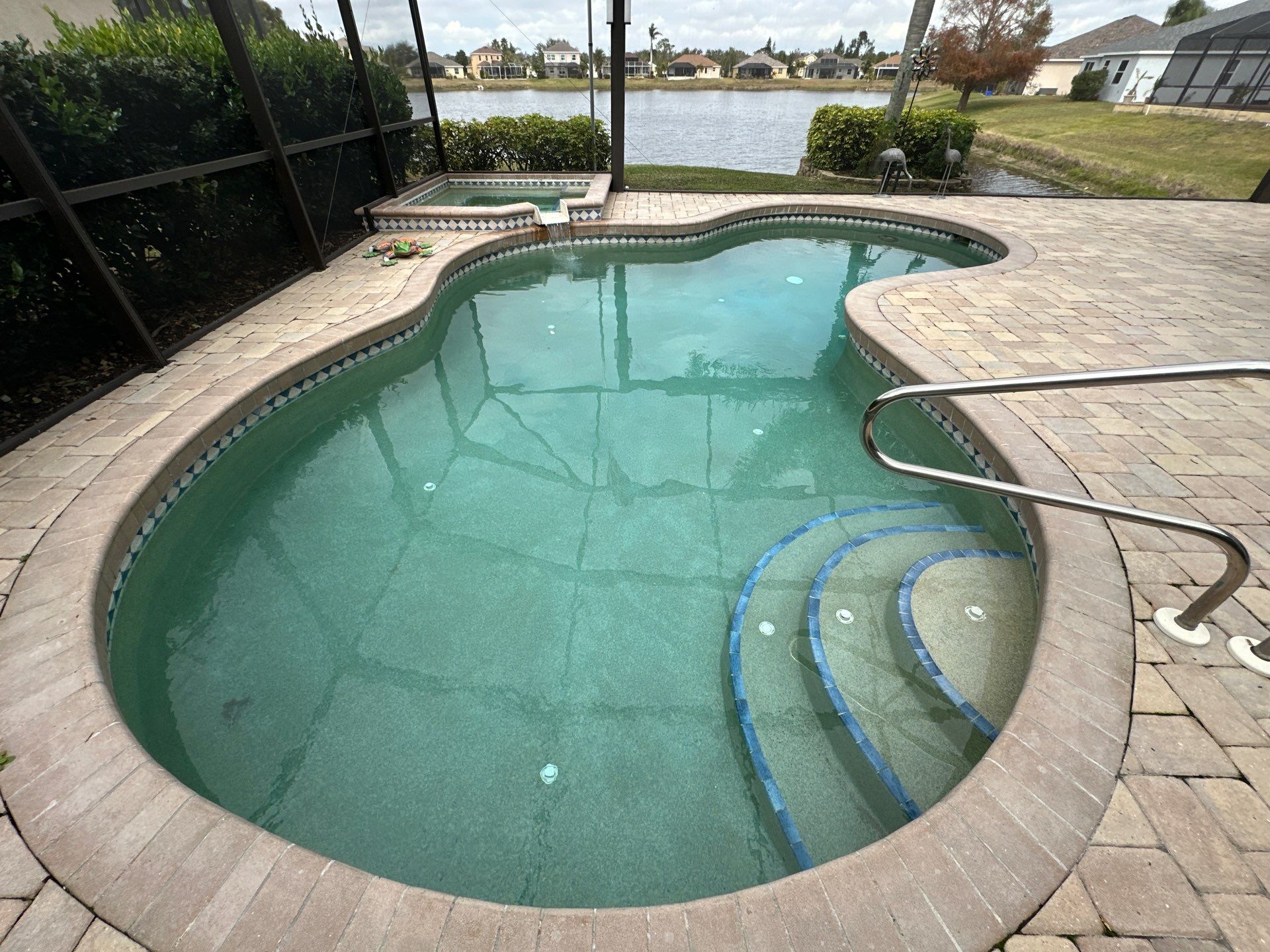 Before and after pool resurfacing in Sarasota FL with Wet Edge Brilliant Blue, Luv Tile, and Citystone Demi Flagstone brick pavers by Nelson Pool Company — before
