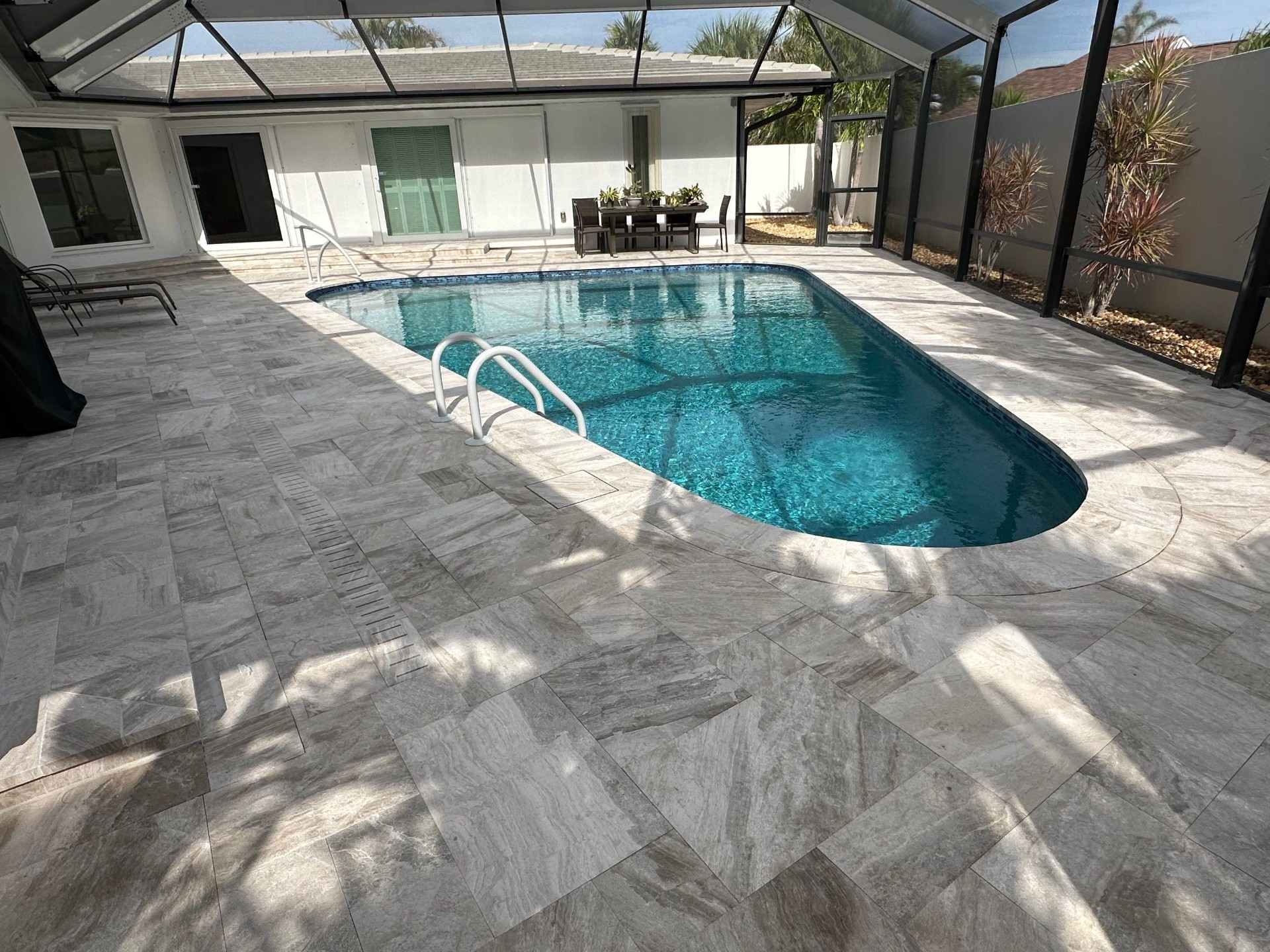 Before and after pool renovation in Siesta Key FL with Pebble Tec, Luv Tile, Platinum Silver Marble, and Pebble Sheen Aqua Blue by Nelson Pool Company — after