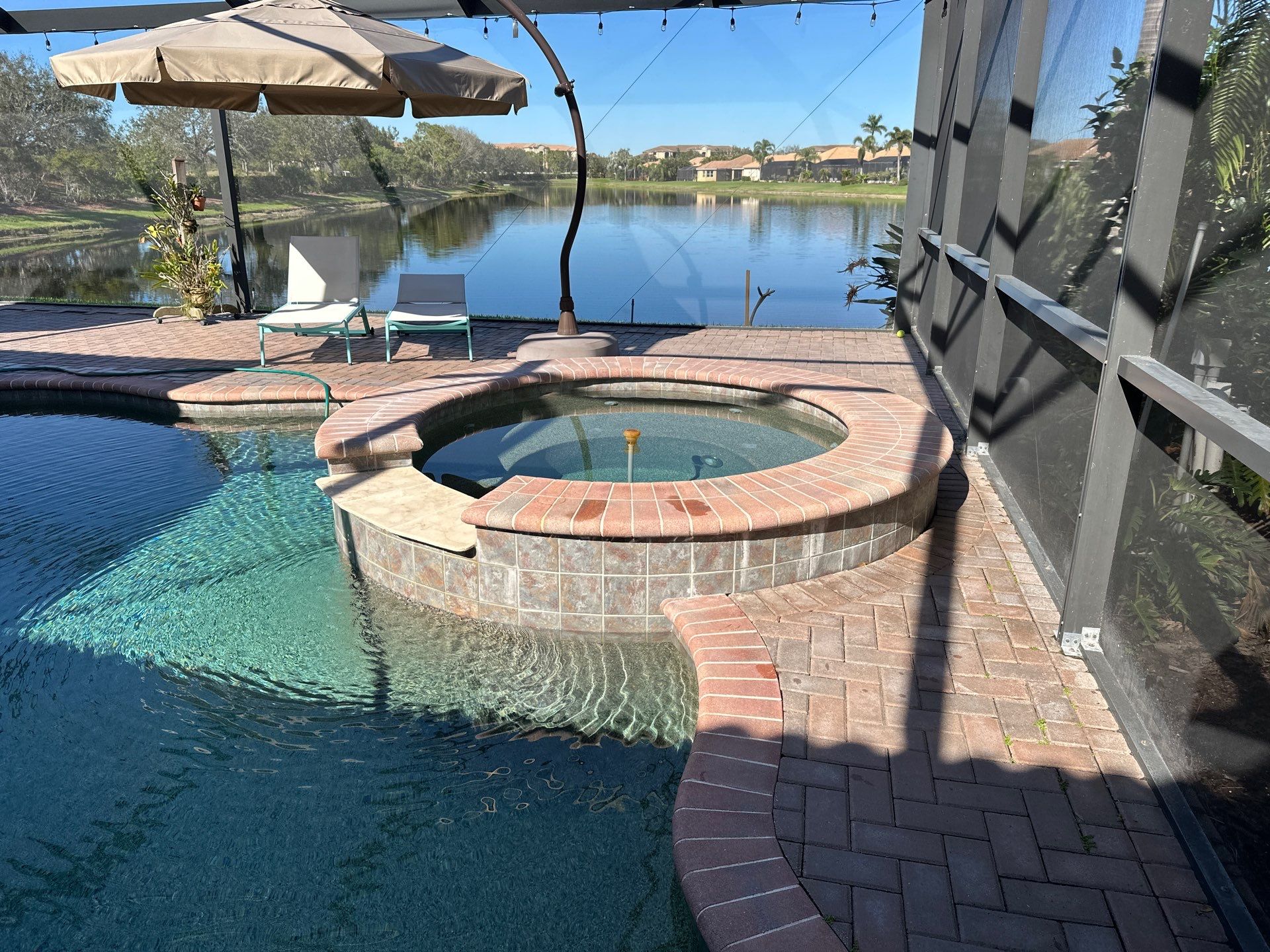 Before and after pool renovation in Anna Maria FL with Alaskan Silver Travertine and Luv Tile by Nelson Pool Company — before