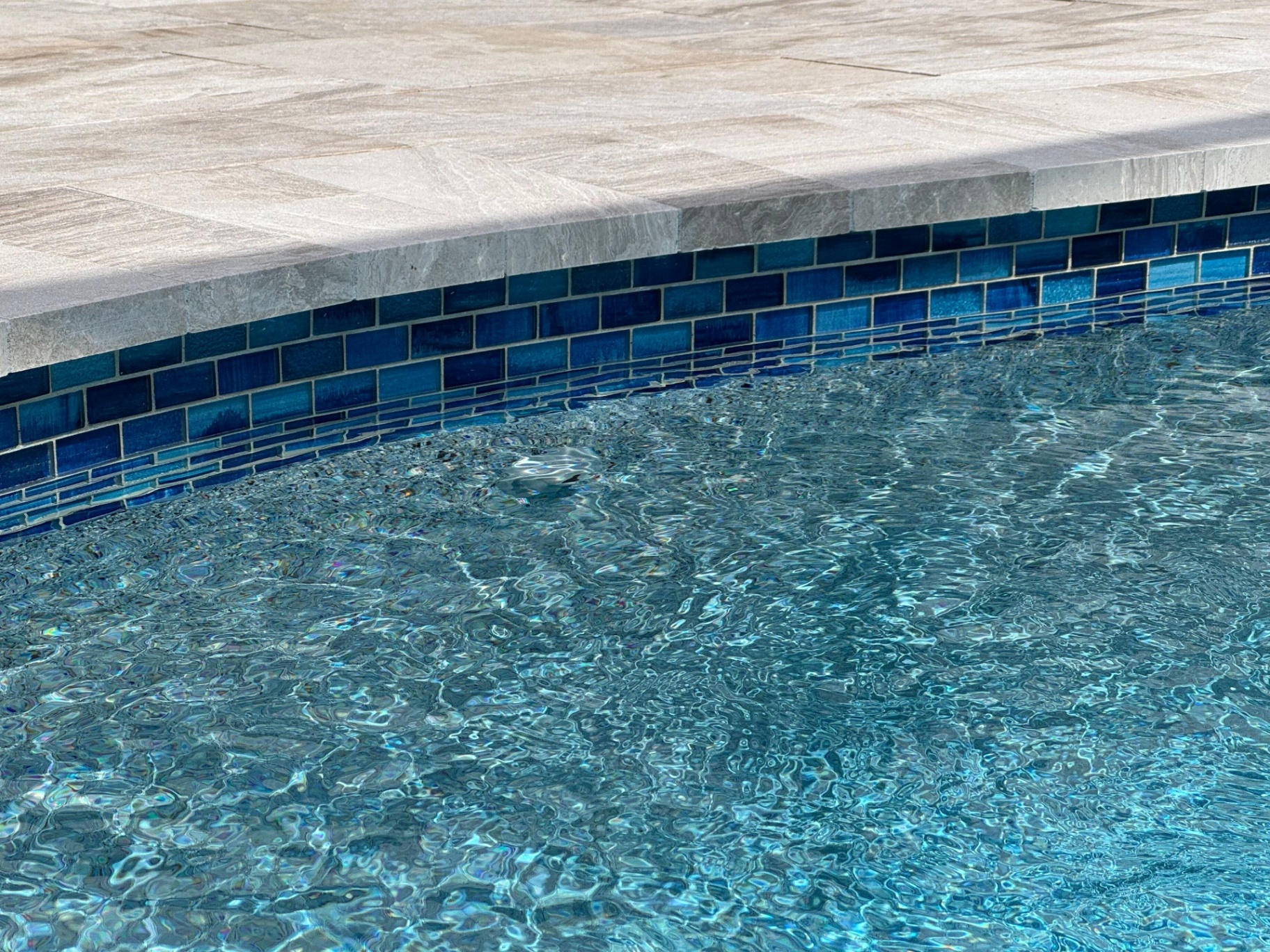 Siesta Key Pool Remodel with Blue Glass Waterline Tile & Travertine Coping in Siesta Key — Nelson Pool Company