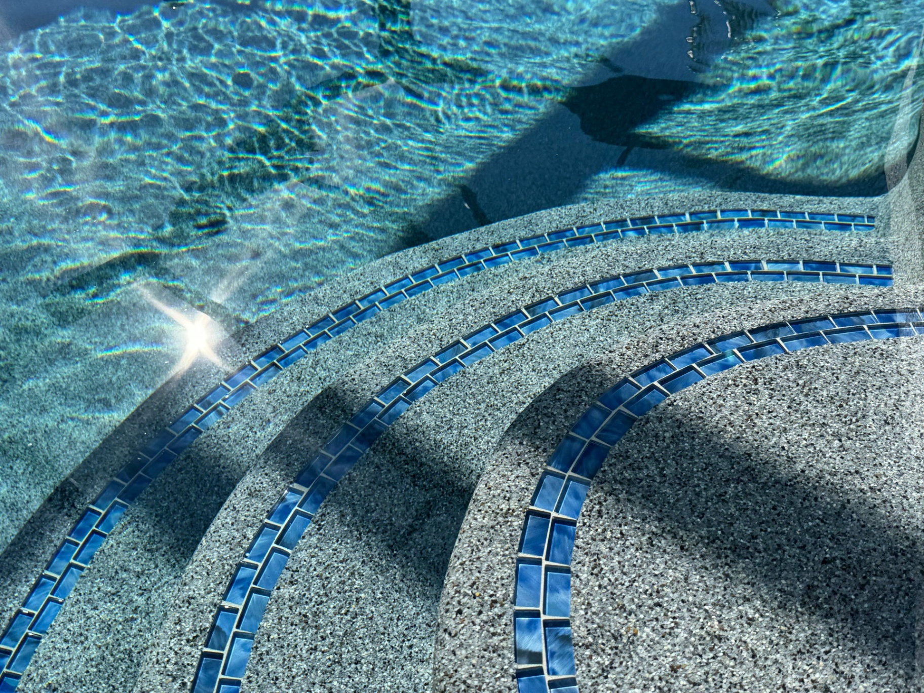 Sarasota Pool Resurfacing with Blue Glass Tile Step Detail in Sarasota — Nelson Pool Company