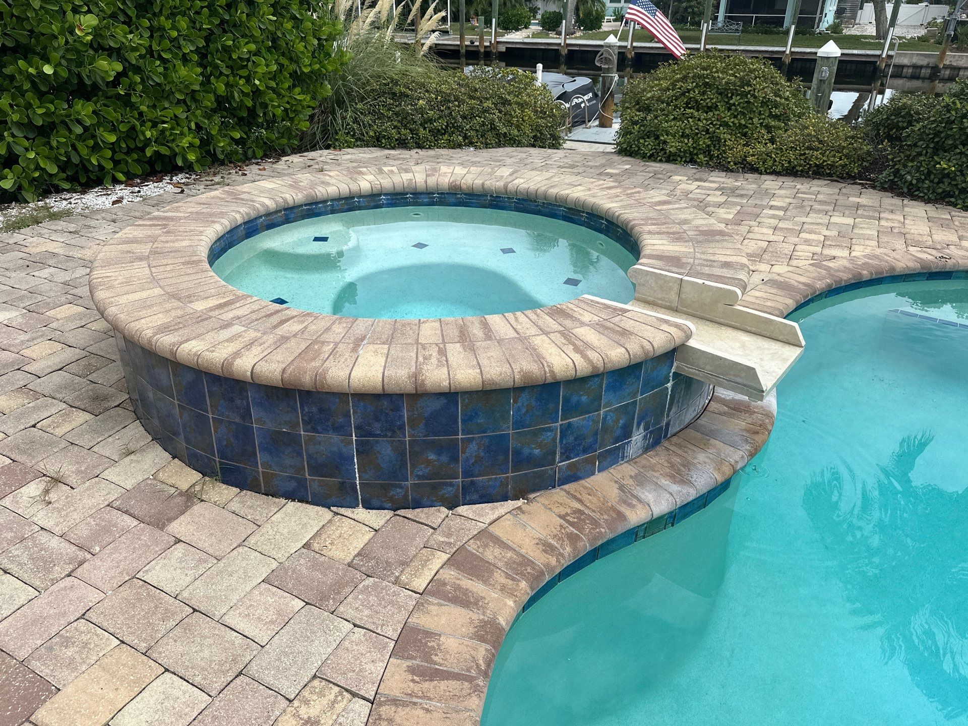 Before and after spa renovation in Longboat Key FL with Crema Bella Marble, Luv Tile, and StoneScapes Aqua White by Nelson Pool Company — before