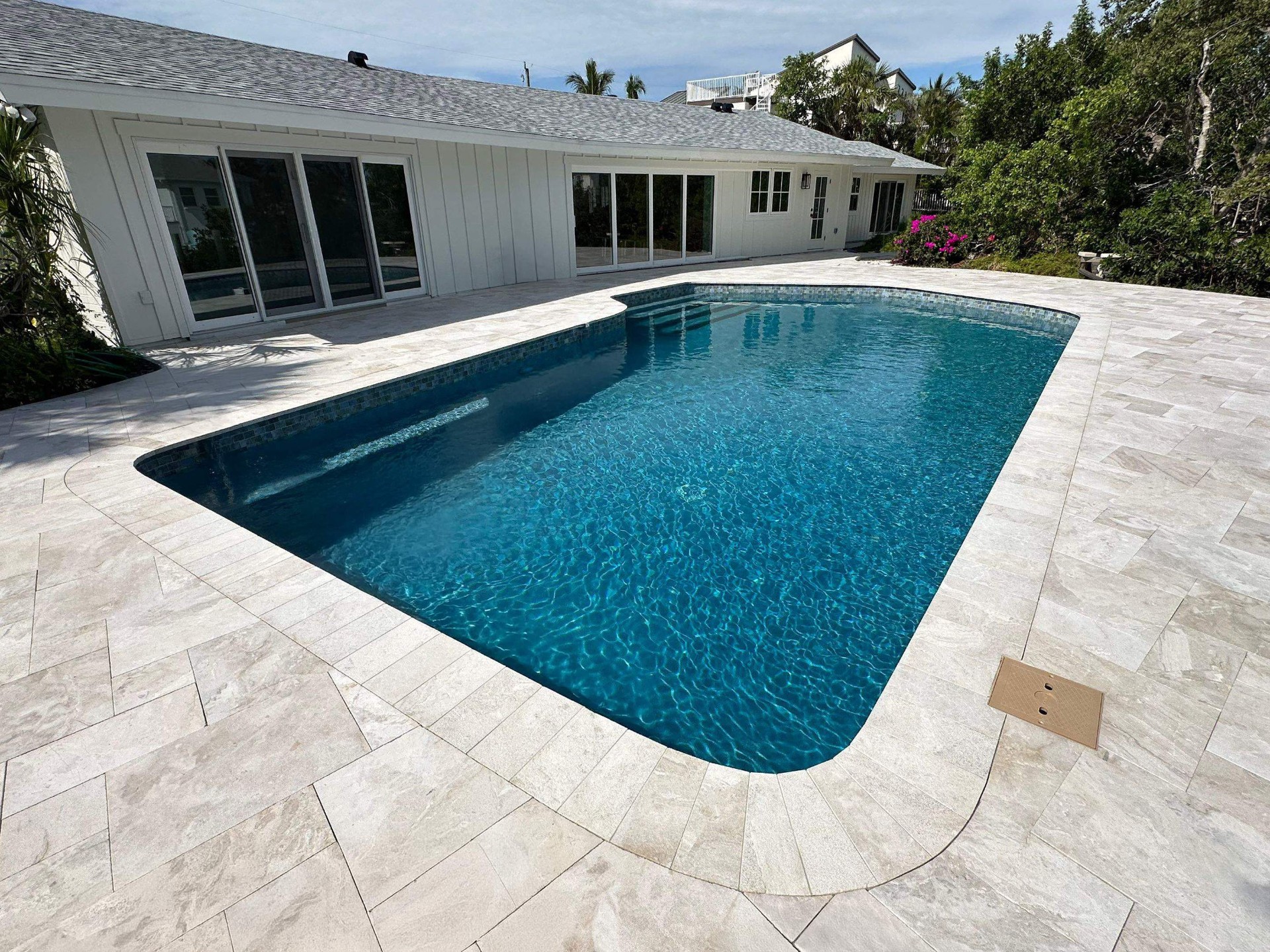 Before and after pool renovation in Holmes Beach FL with Royal Beige Marble, Luv Tile, and StoneScapes Aqua Blue by Nelson Pool Company — after