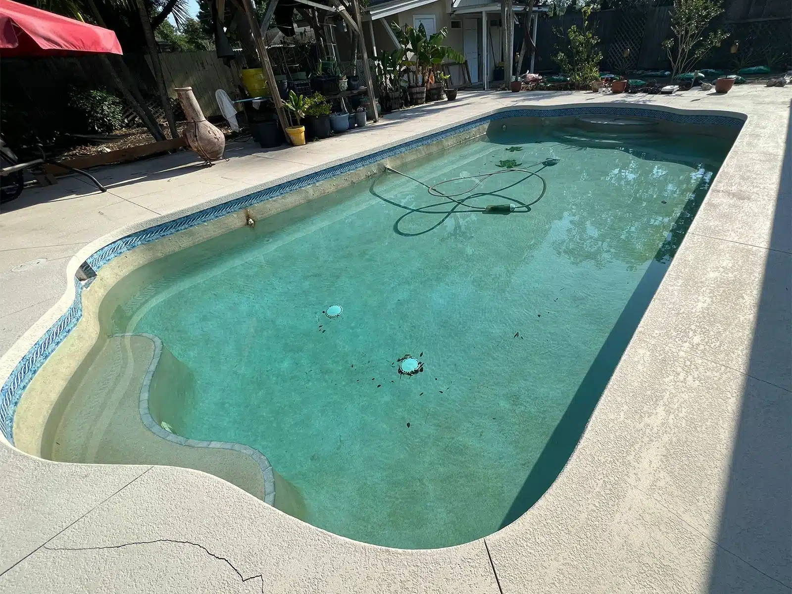 Before and after pool remodel with tile coping and pavers in Sarasota FL — before