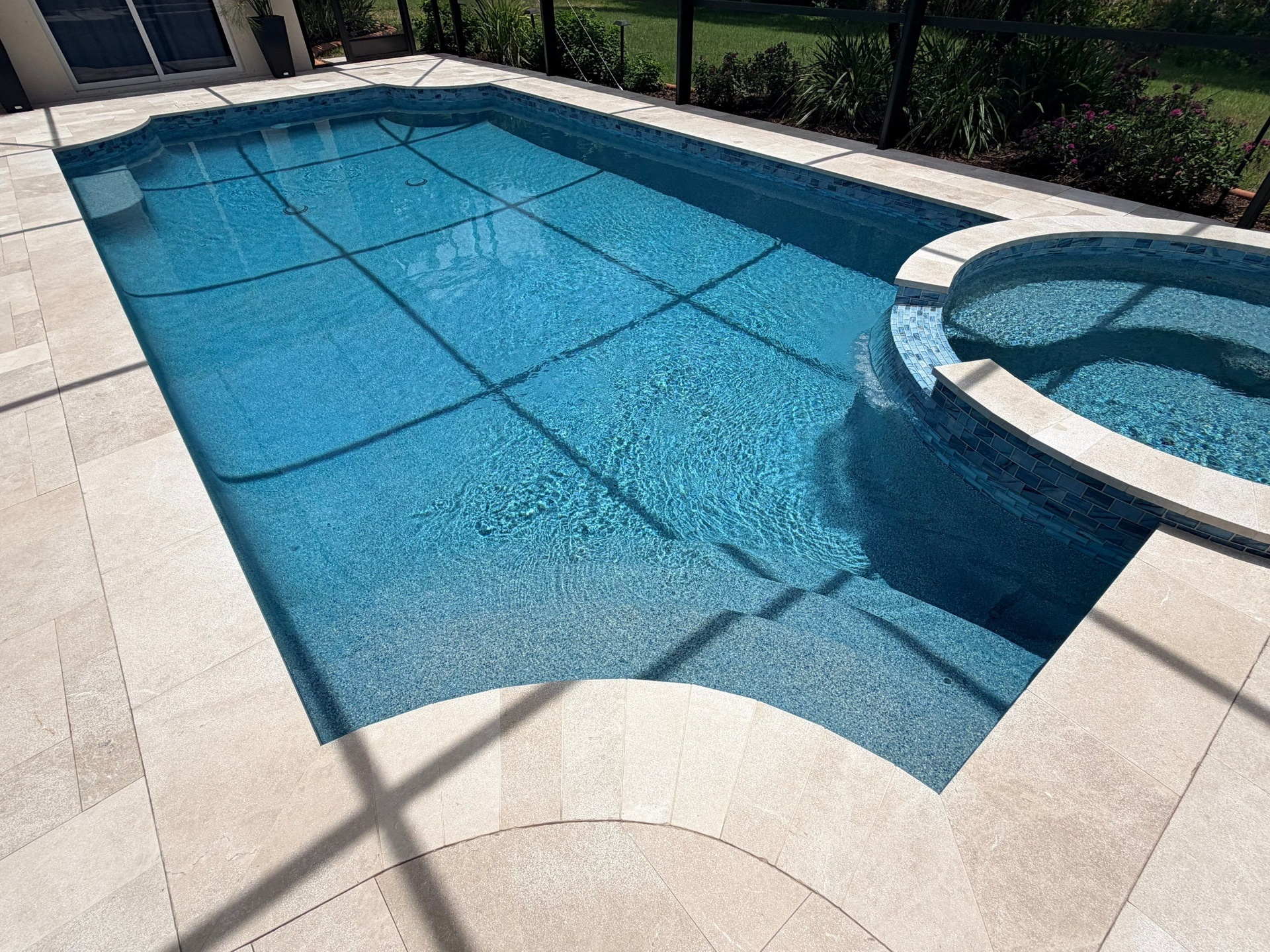 Before and after pool resurfacing in Bradenton FL with Wet Edge Brilliant Blue, NPT Borghini, Luv Tile, and Crema Bella Marble pavers by Nelson Pool Company — after