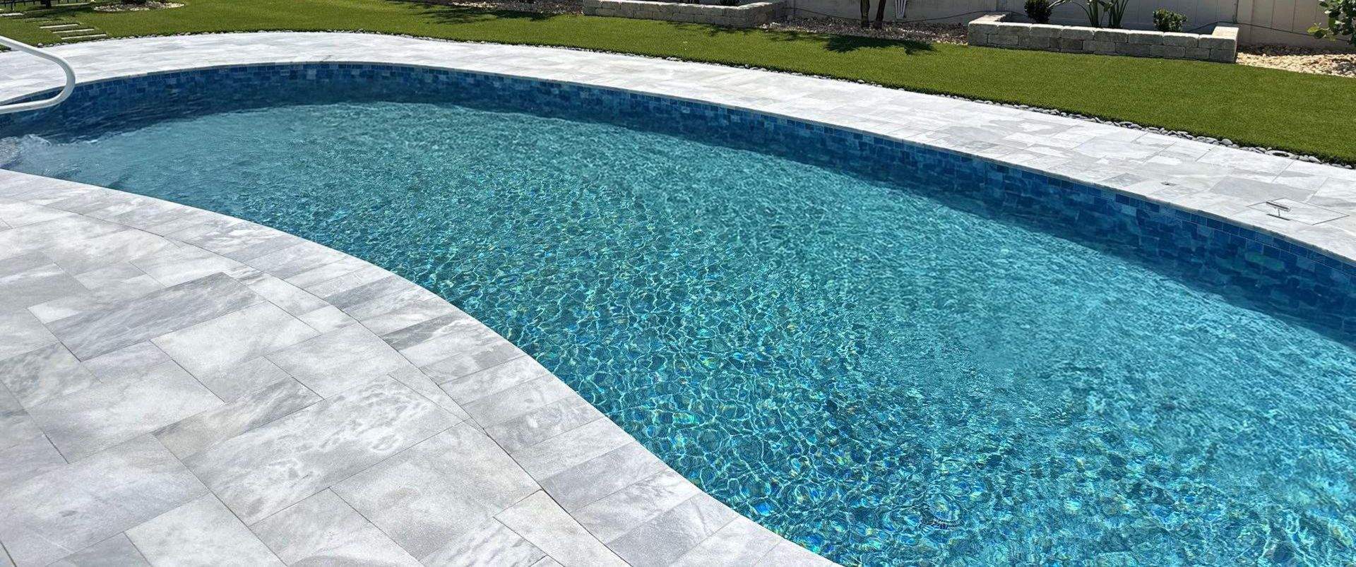 Palmetto Pool Renovation with Curved Marble Deck and Blue Waterline Tile in Palmetto — Nelson Pool Company