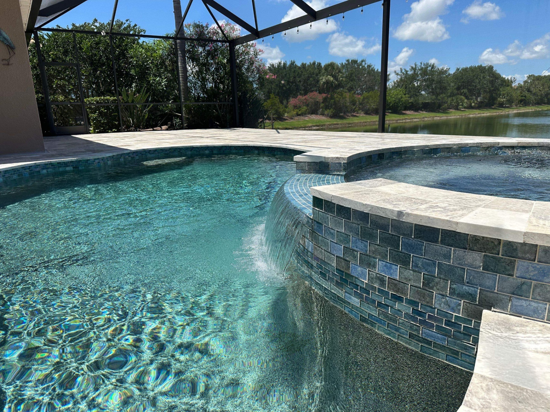 Complete pool renovation with new tile, coping, and spa spillover by Nelson Pool Company