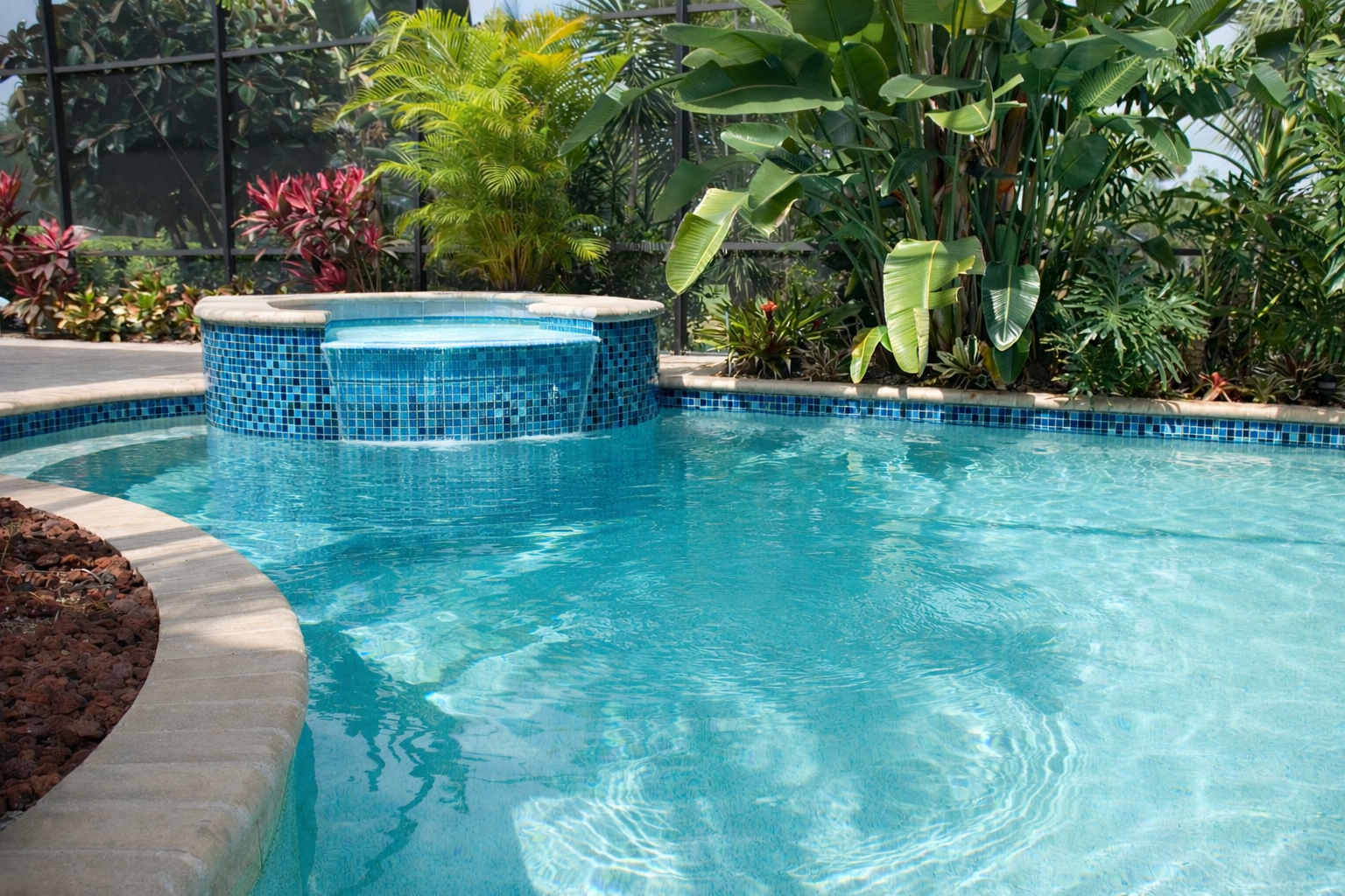 Freshly resurfaced pool interior finish with mosaic tile by Nelson Pool Company
