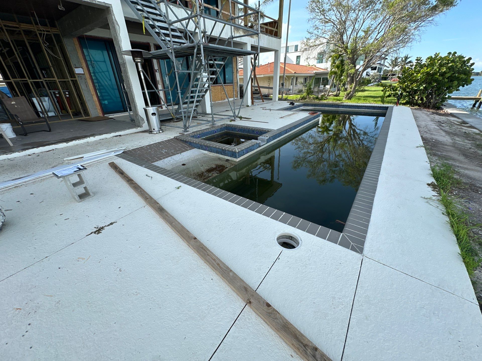 Before and after pool resurfacing in Sarasota FL with Pebble Tec Aqua Essence by Nelson Pool Company — before