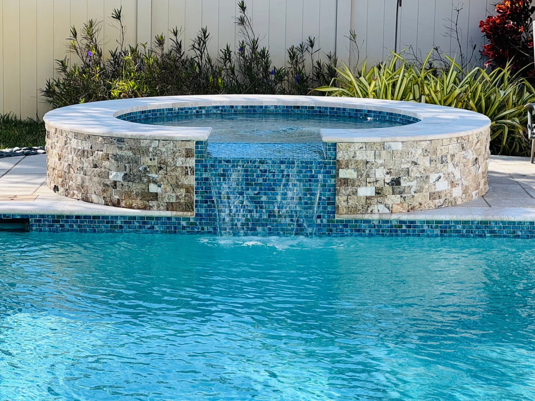 Venice Pool & Spa Renovation with Stacked Stone Spa & Glass Tile Spillway in Venice — Nelson Pool Company