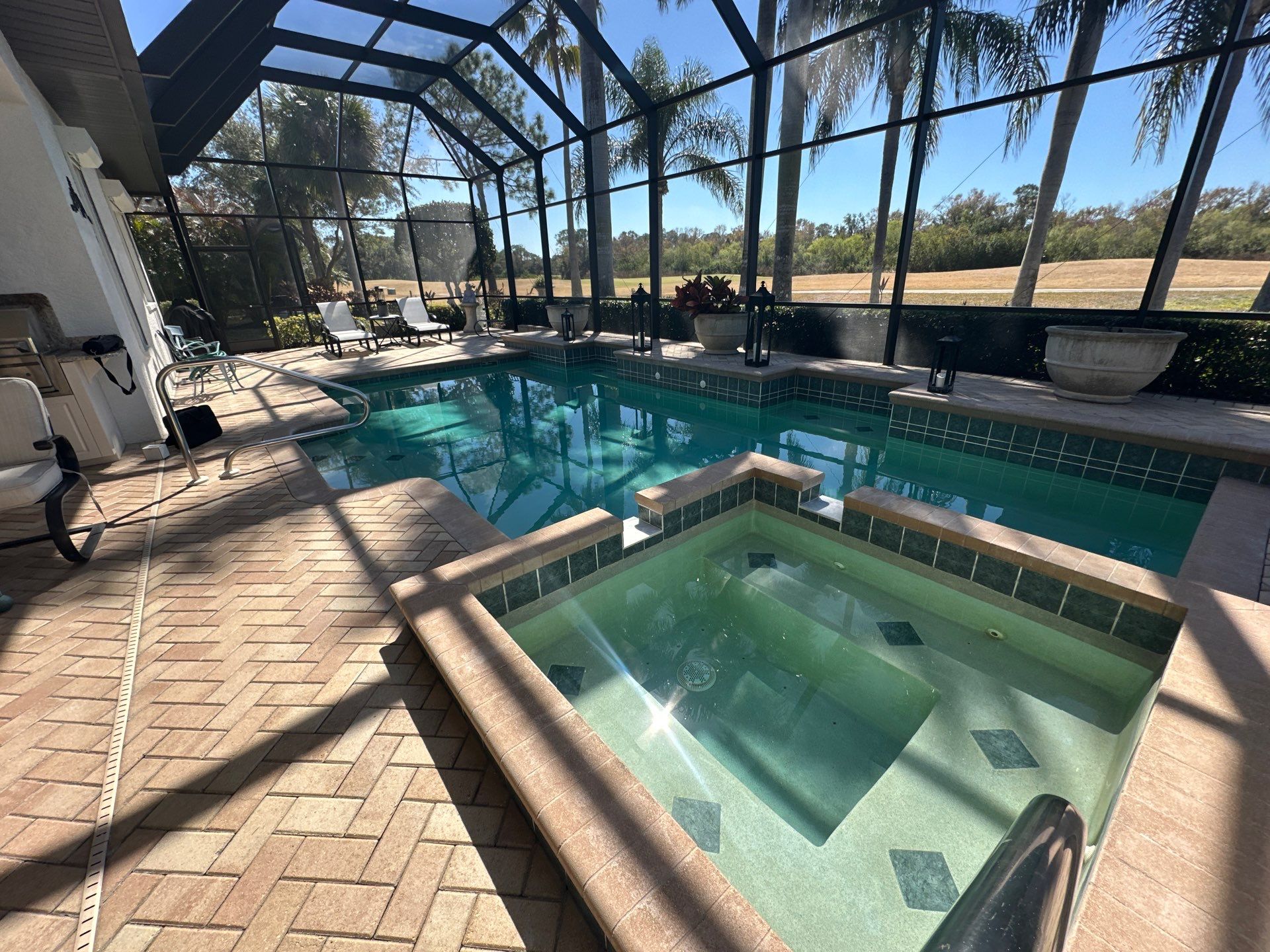 Before and after pool renovation in Lakewood Ranch FL with Wet Edge Brilliant Blue, Abalone Shell, and Mykonos Marble pavers by Nelson Pool Company — before