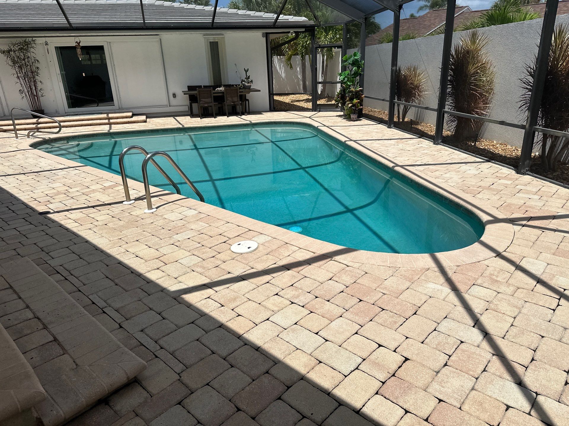 Before and after pool renovation in Siesta Key FL with Pebble Tec, Luv Tile, Platinum Silver Marble, and Pebble Sheen Aqua Blue by Nelson Pool Company — before