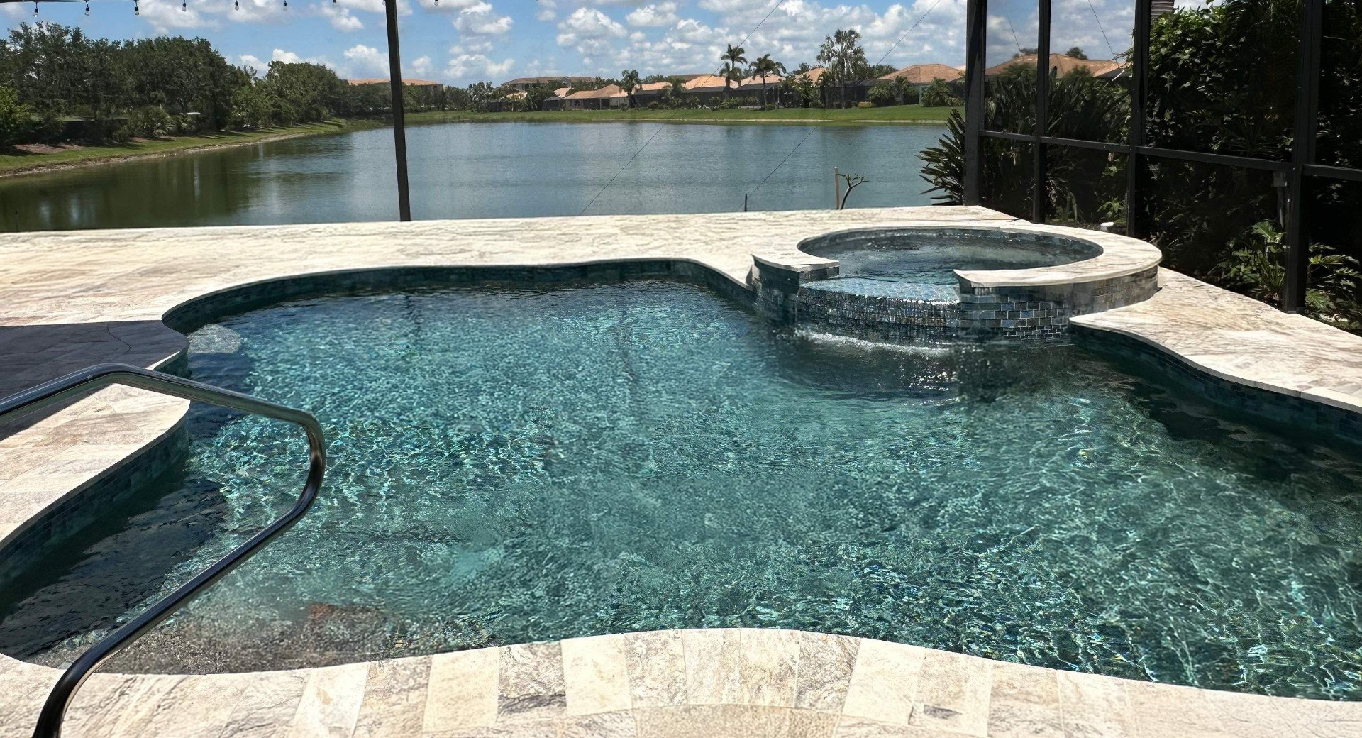 Before and after pool remodel in Anna Maria FL with Alaskan Silver Travertine and Luv Tile by Nelson Pool Company — after