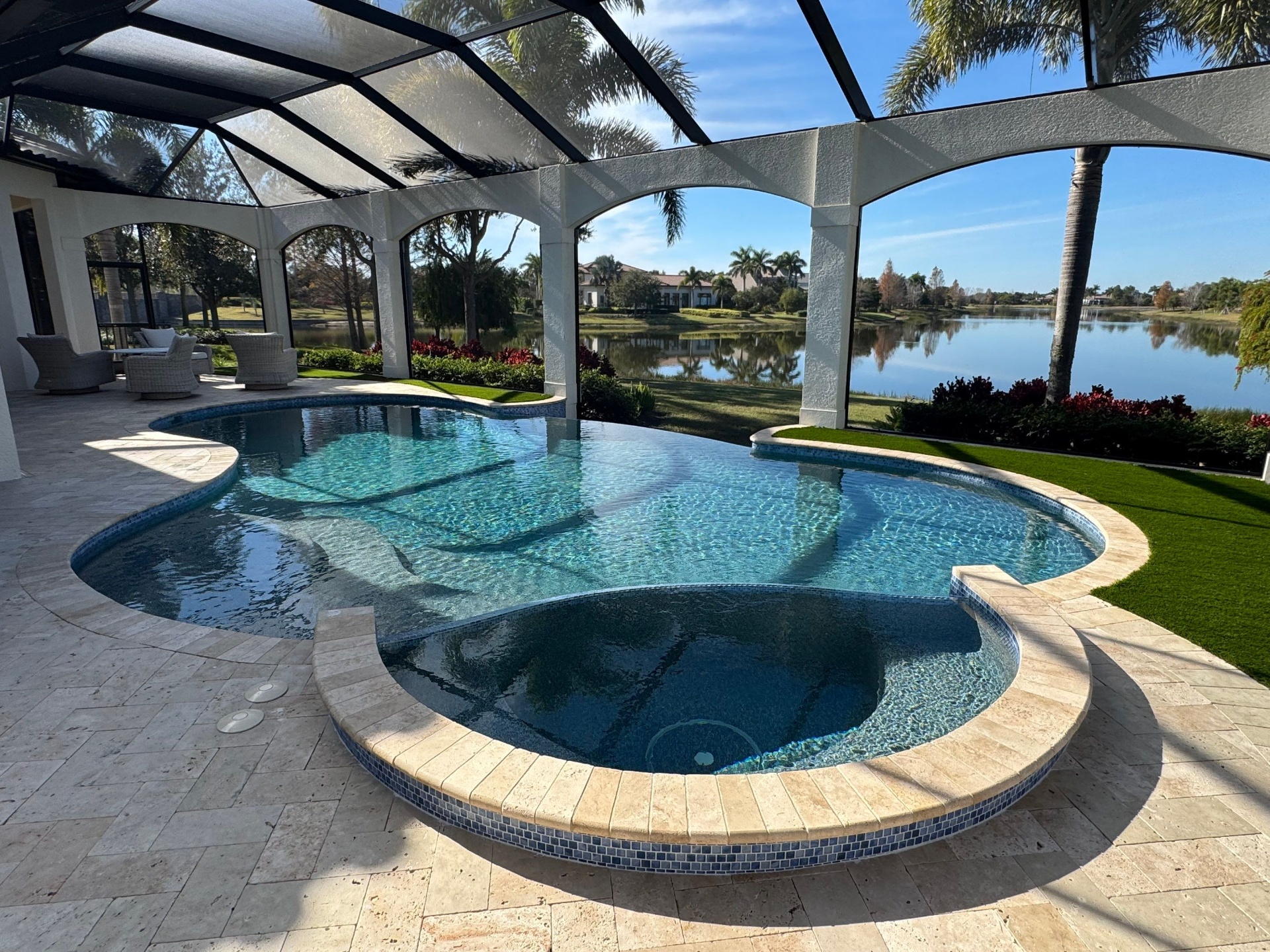 Pool & Spa Renovation with Travertine Deck Overlooking the Lake in Lakewood Ranch — Nelson Pool Company