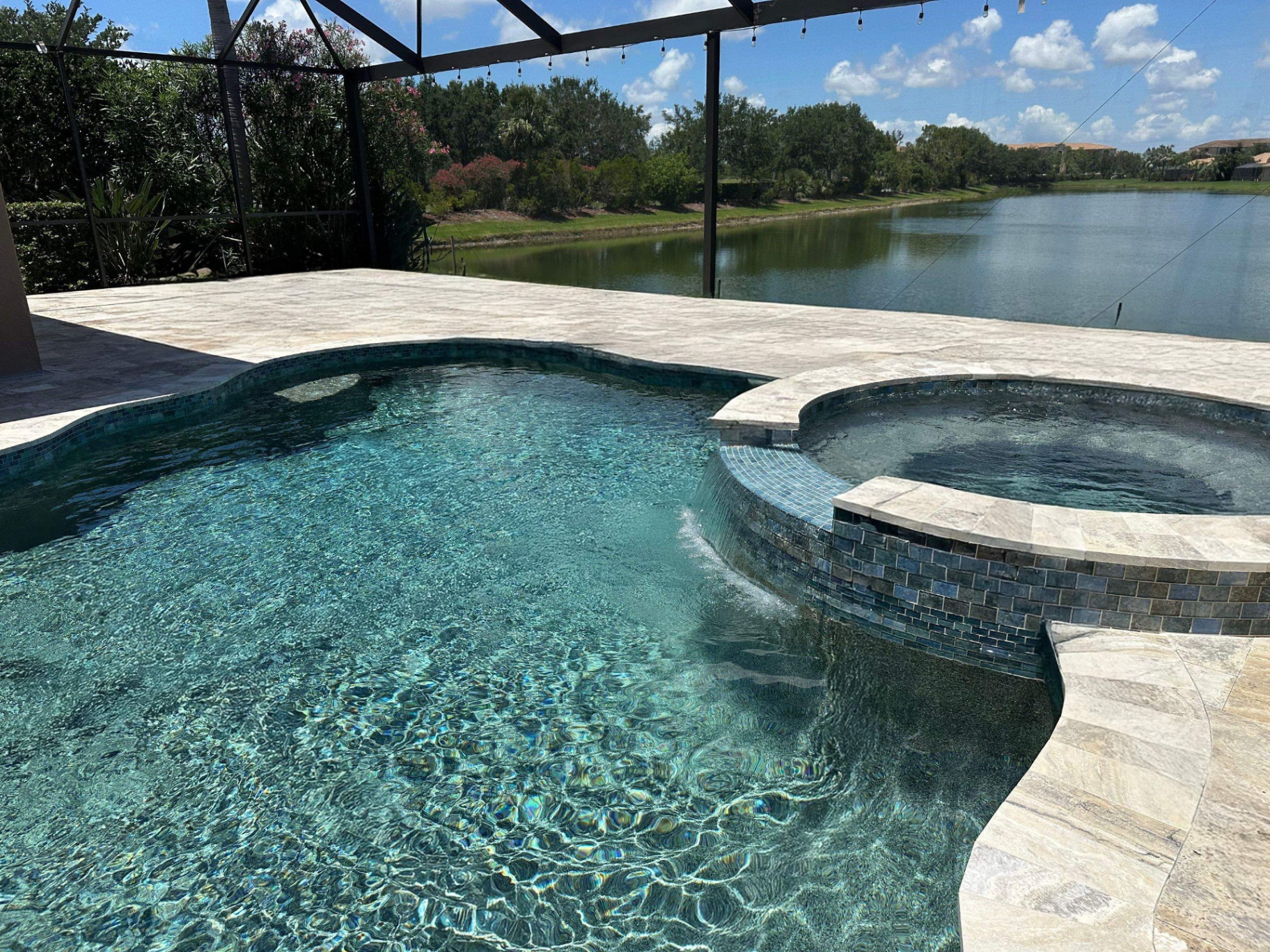 Before and after pool renovation in Anna Maria FL with Alaskan Silver Travertine and Luv Tile by Nelson Pool Company — after