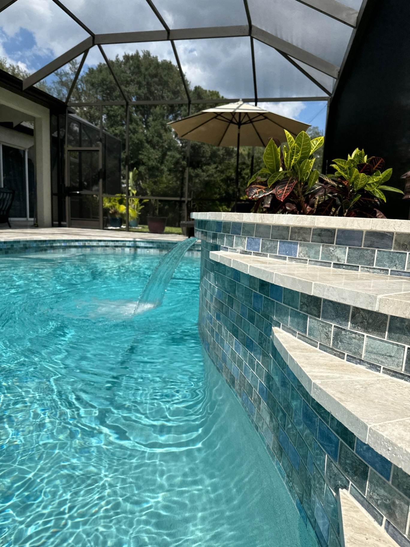 Renovated pool with new tile, coping, and spa spillover by Nelson Pool Company in Southwest Florida