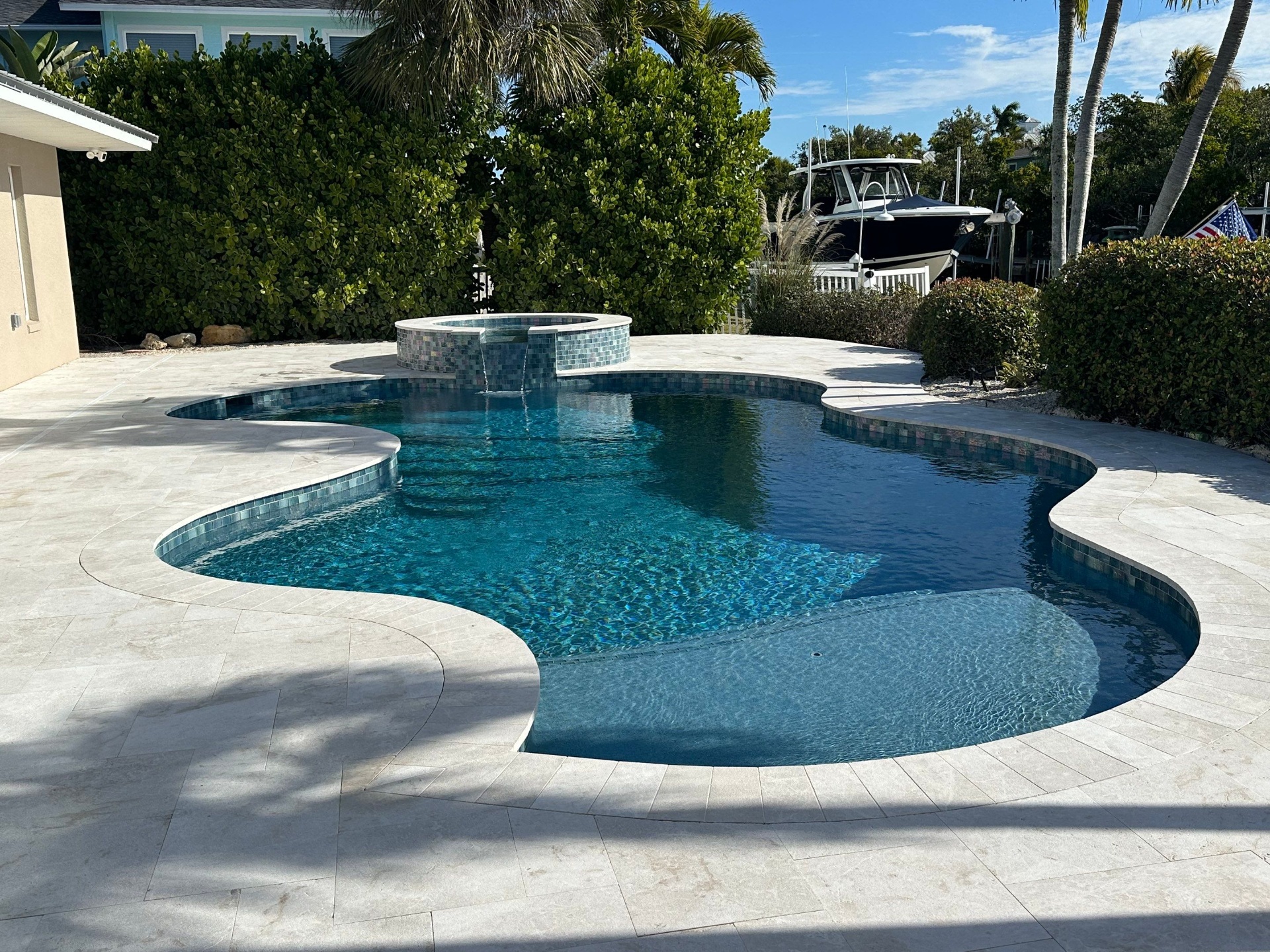 Before and after pool renovation in Longboat Key FL with Crema Bella Marble, Luv Tile, and StoneScapes Aqua White by Nelson Pool Company — after