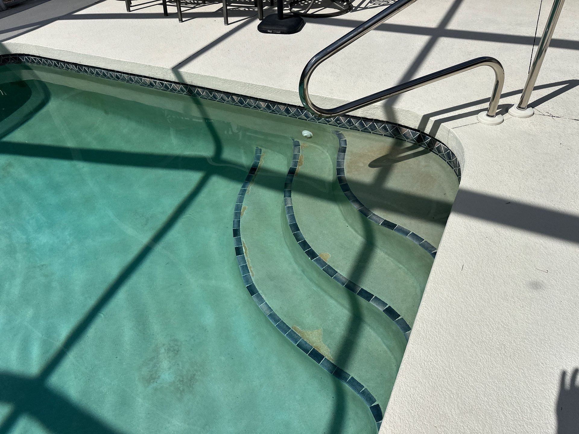 Before and after pool remodel in Venice FL with Norwegian River Travertine, Luv Tile, and Pebble Sheen Blue Surf by Nelson Pool Company — before