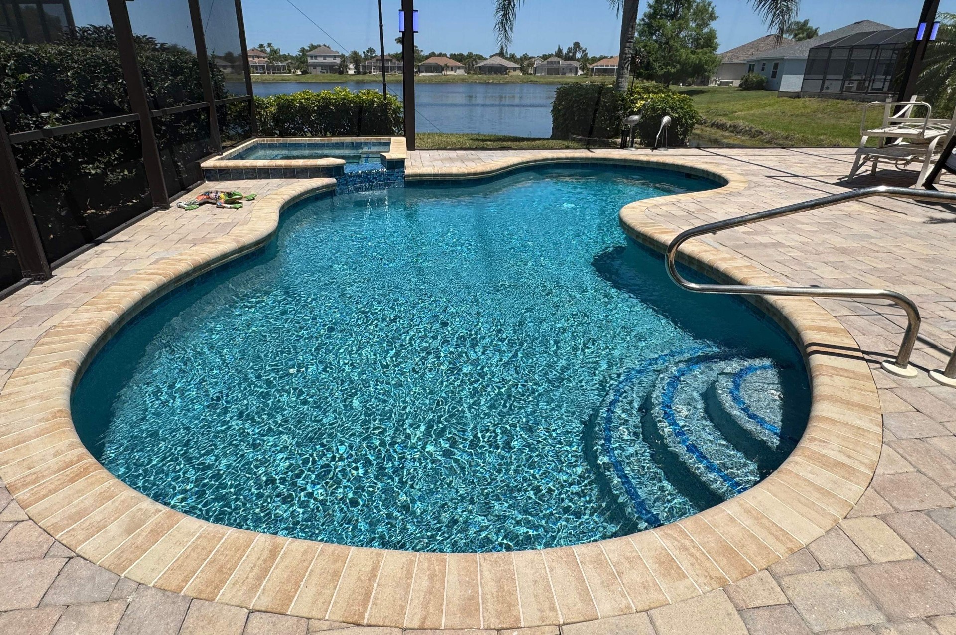 Before and after pool resurfacing in Sarasota FL with Wet Edge Brilliant Blue, Luv Tile, and Citystone Demi Flagstone brick pavers by Nelson Pool Company — after